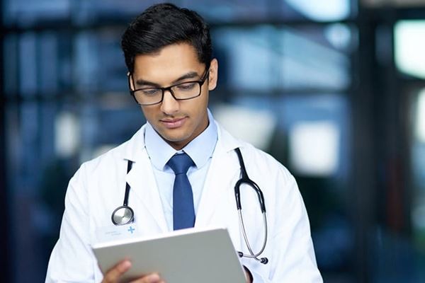 Shot of a young doctor using a digital tablet in a hospital.